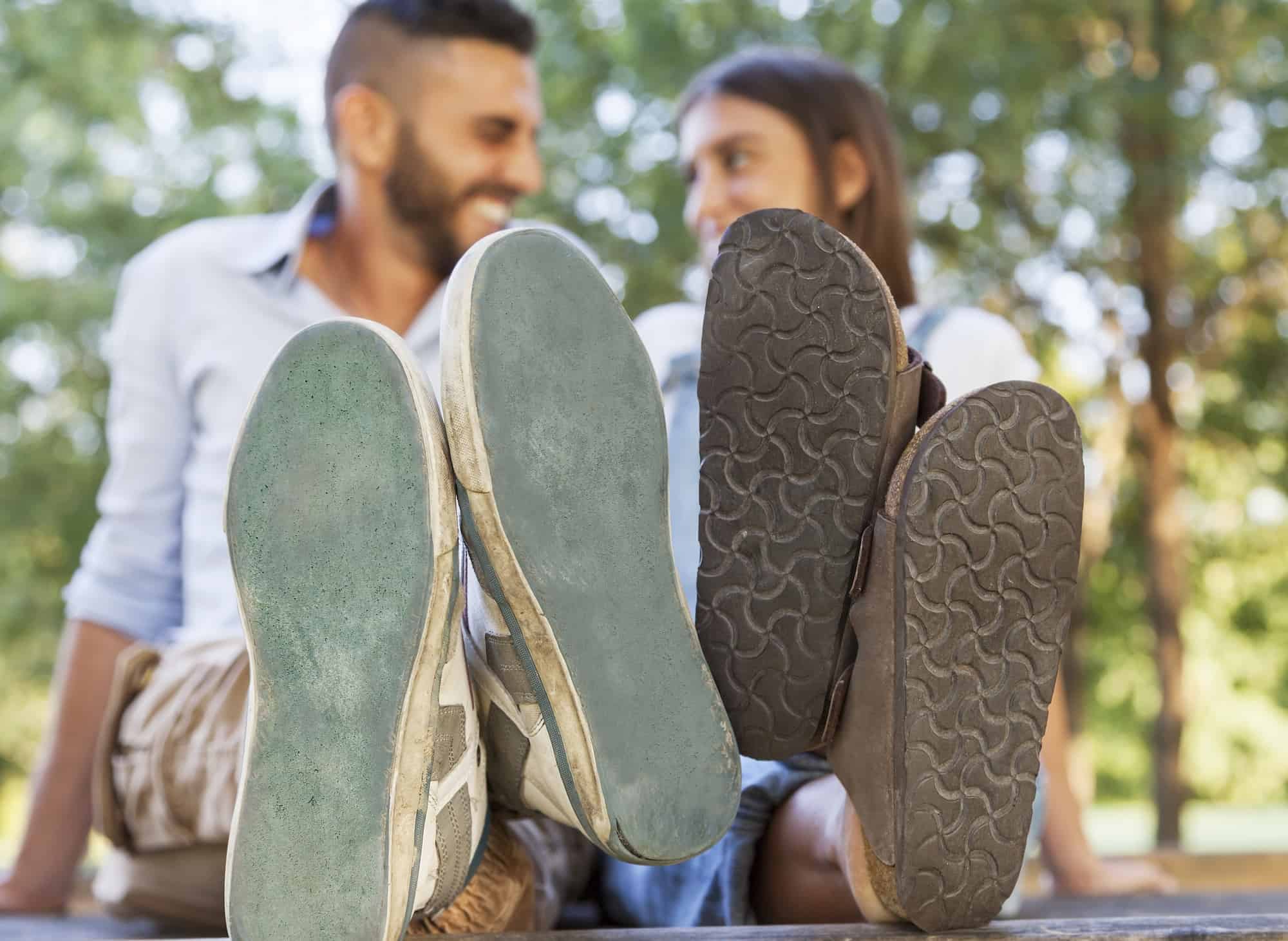shoe soles in foreground with people smiling